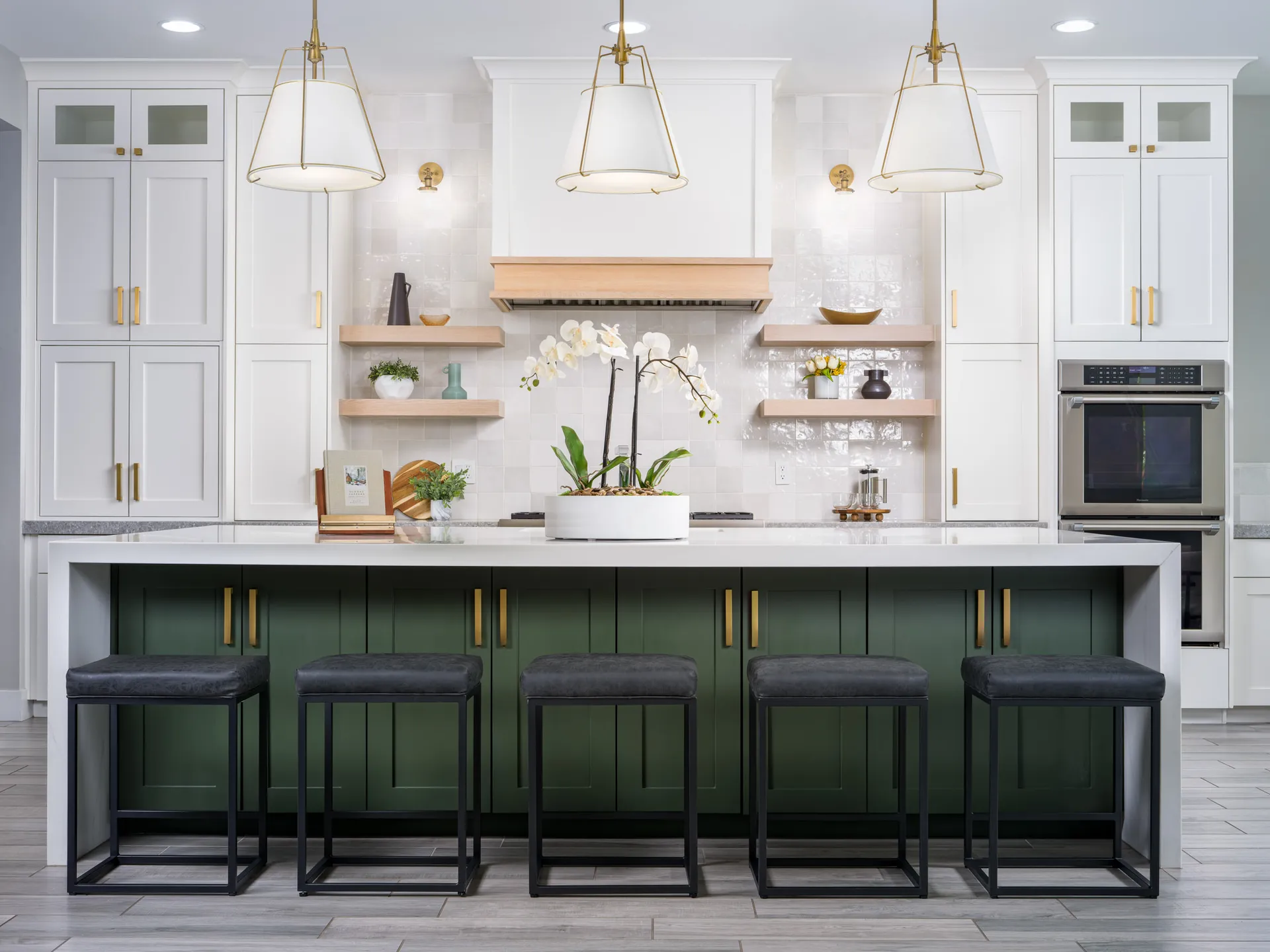 Luxury Home Staging featuring a modern kitchen with a green island, white cabinets, gold accents, and luxury interior design elements.