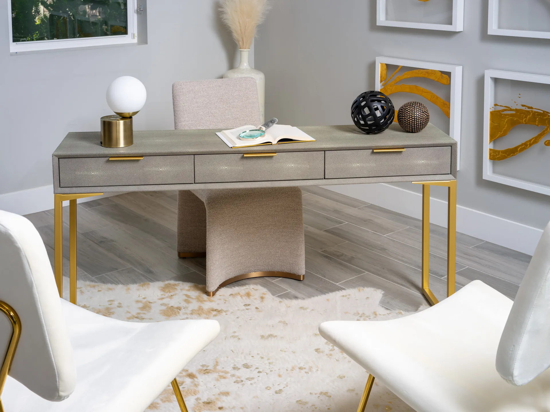 Elegant modern workspace with golden accents, neutral tones, and stylish decor in a luxury staged home.
