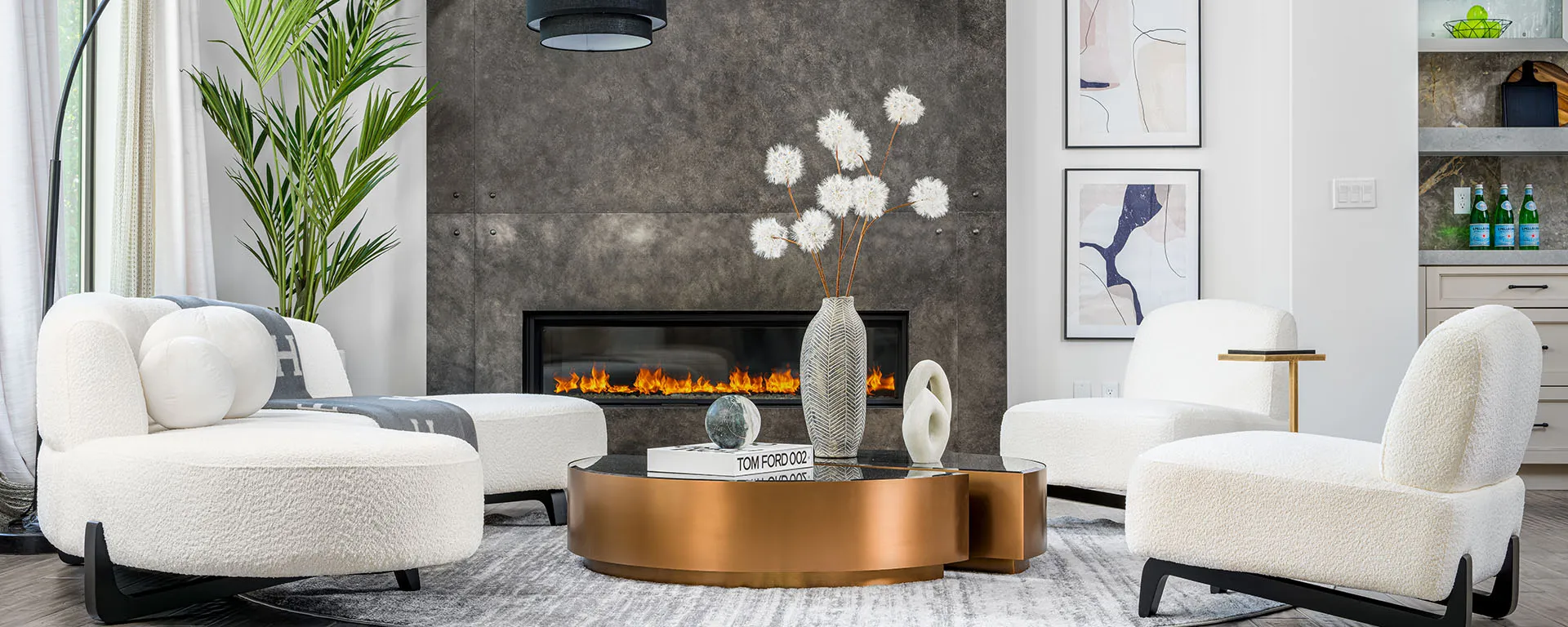 Modern living room with white chairs, gold coffee table, and fireplace