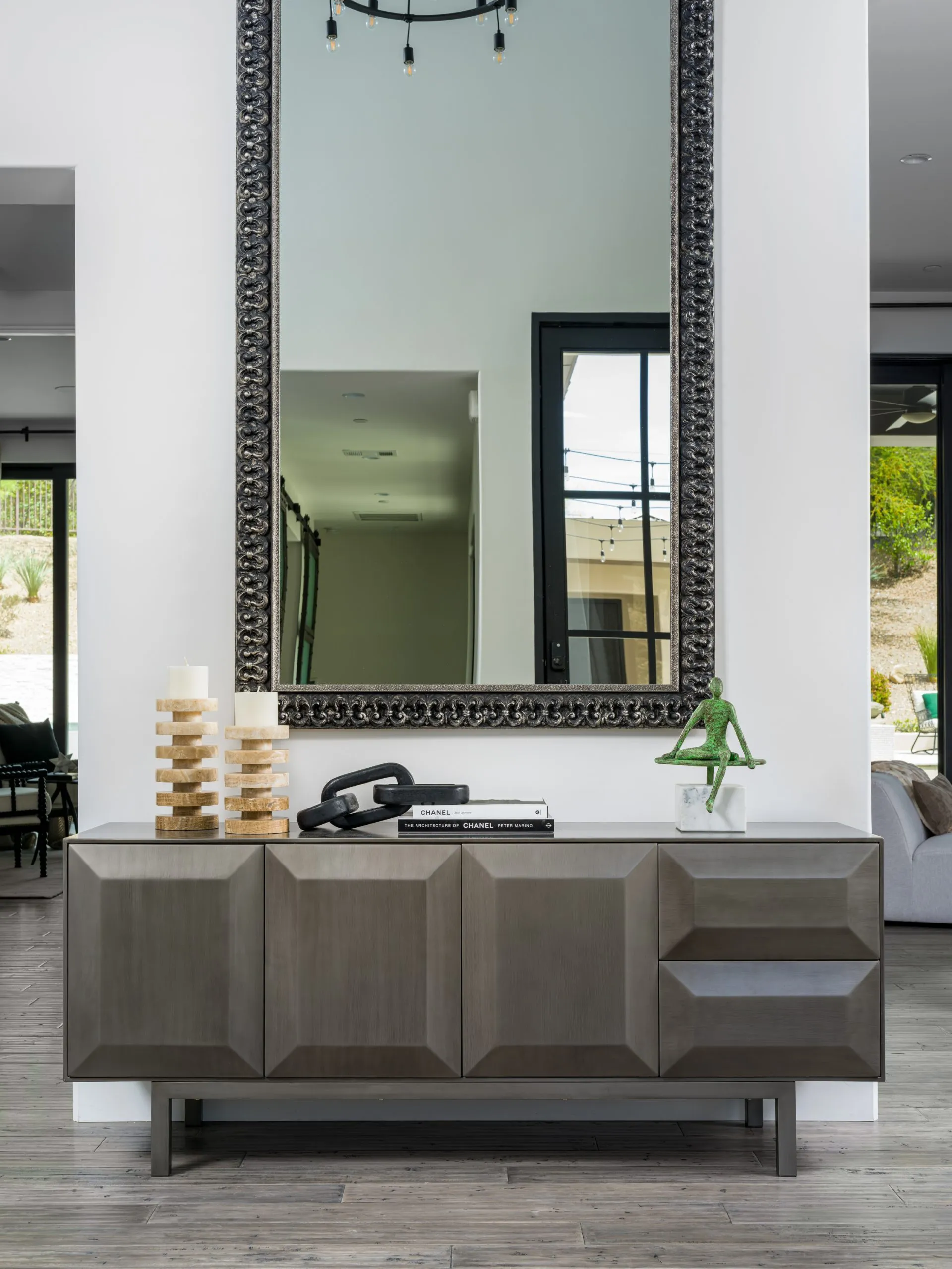 Modern console table with geometric design, large mirror, and decorative items