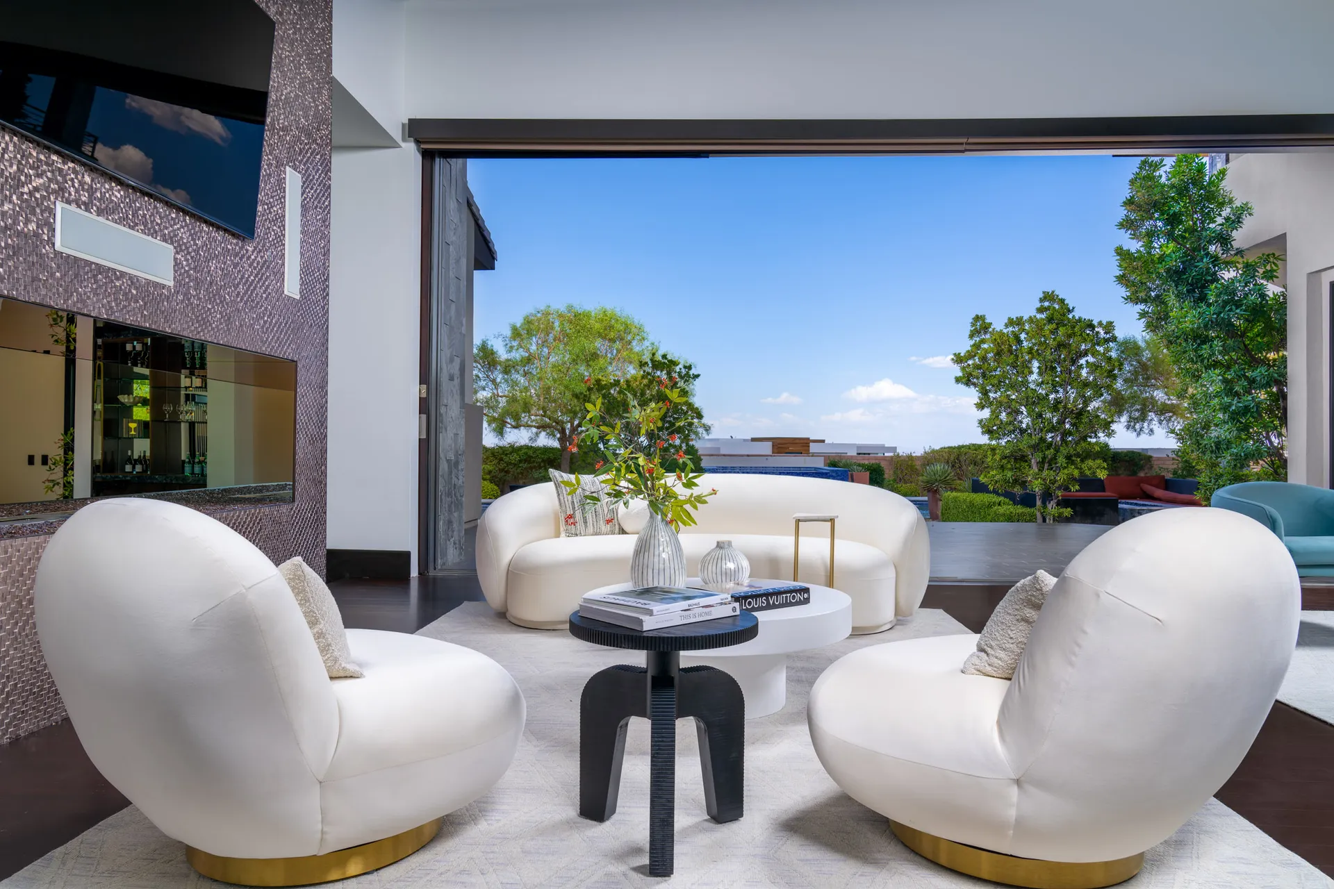 Outdoor lounge area with modern furniture and scenic view.