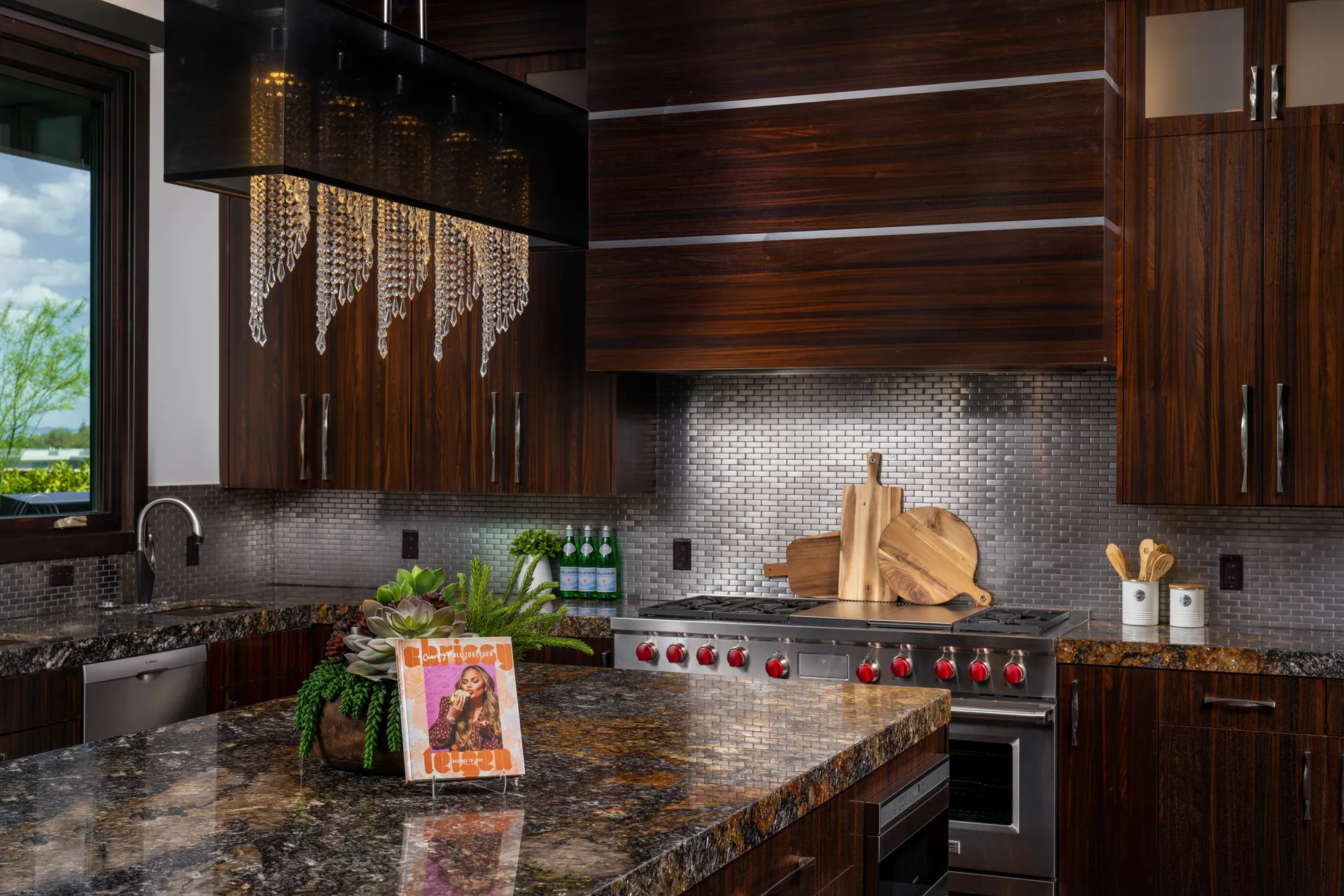 Modern kitchen with dark wood cabinetry, large island, and pendant lighting.