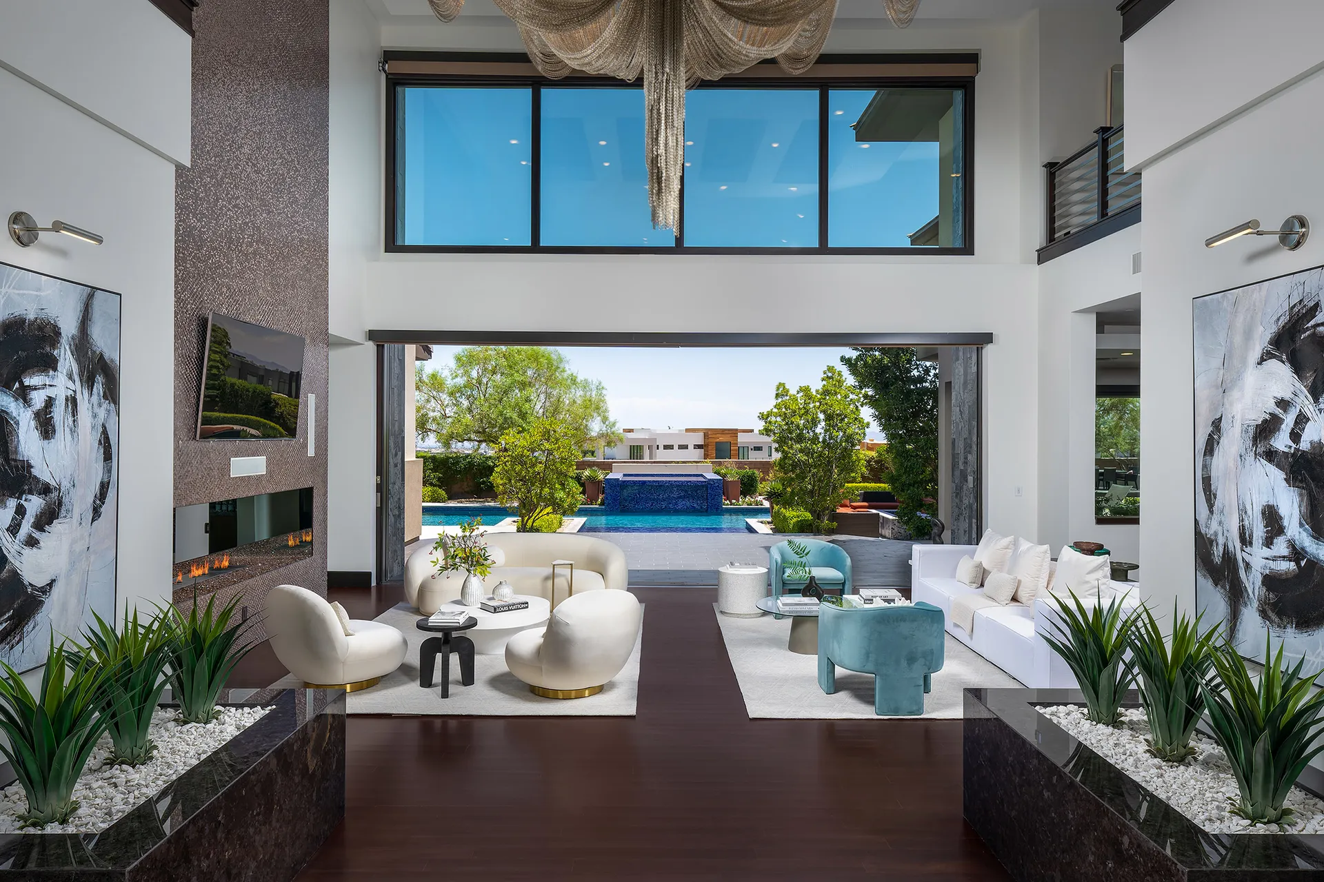 A luxurious living room with contemporary furniture, abstract artwork, and a grand