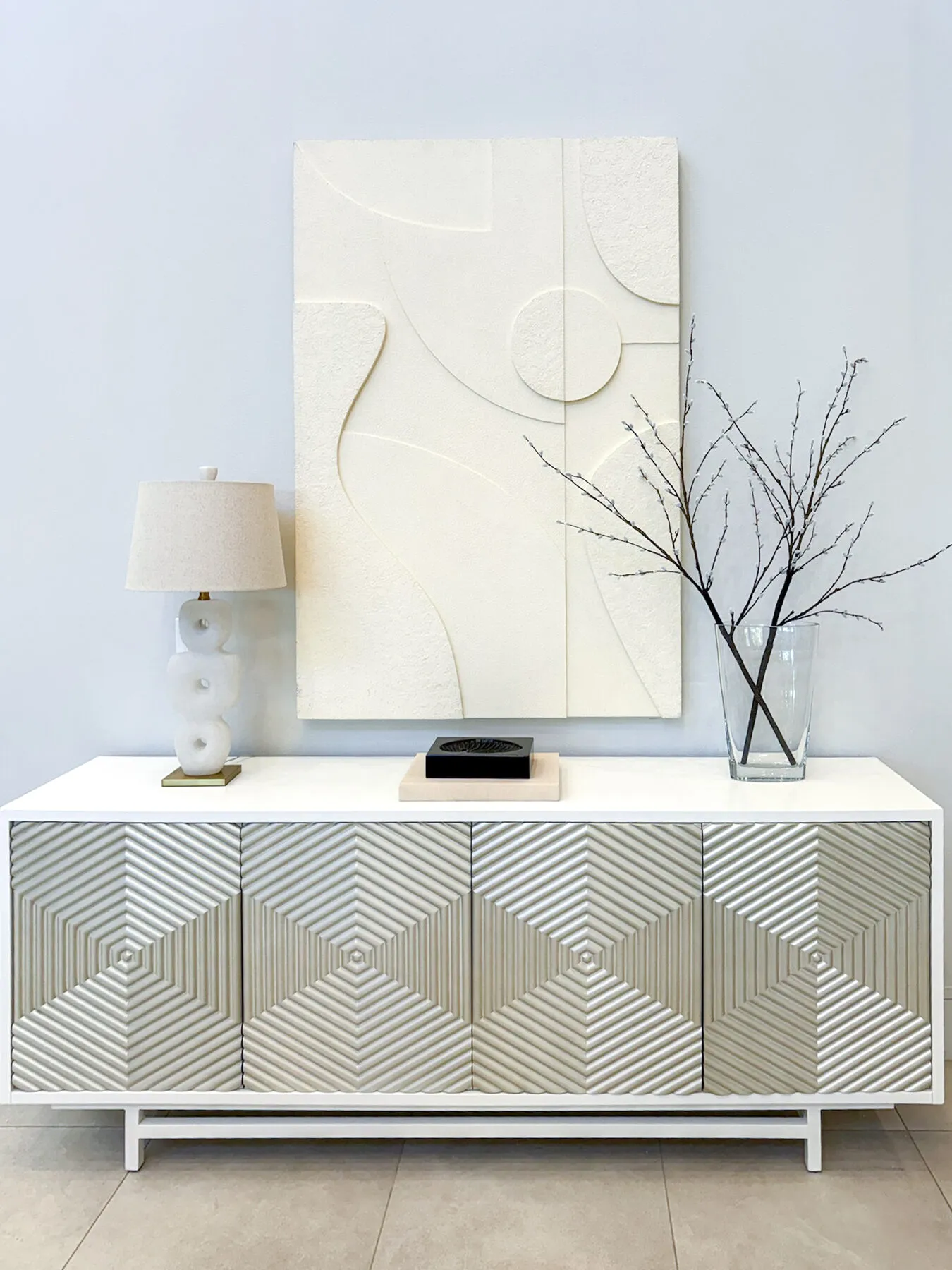 Sculptural Plaster Art Over a Geometric Console