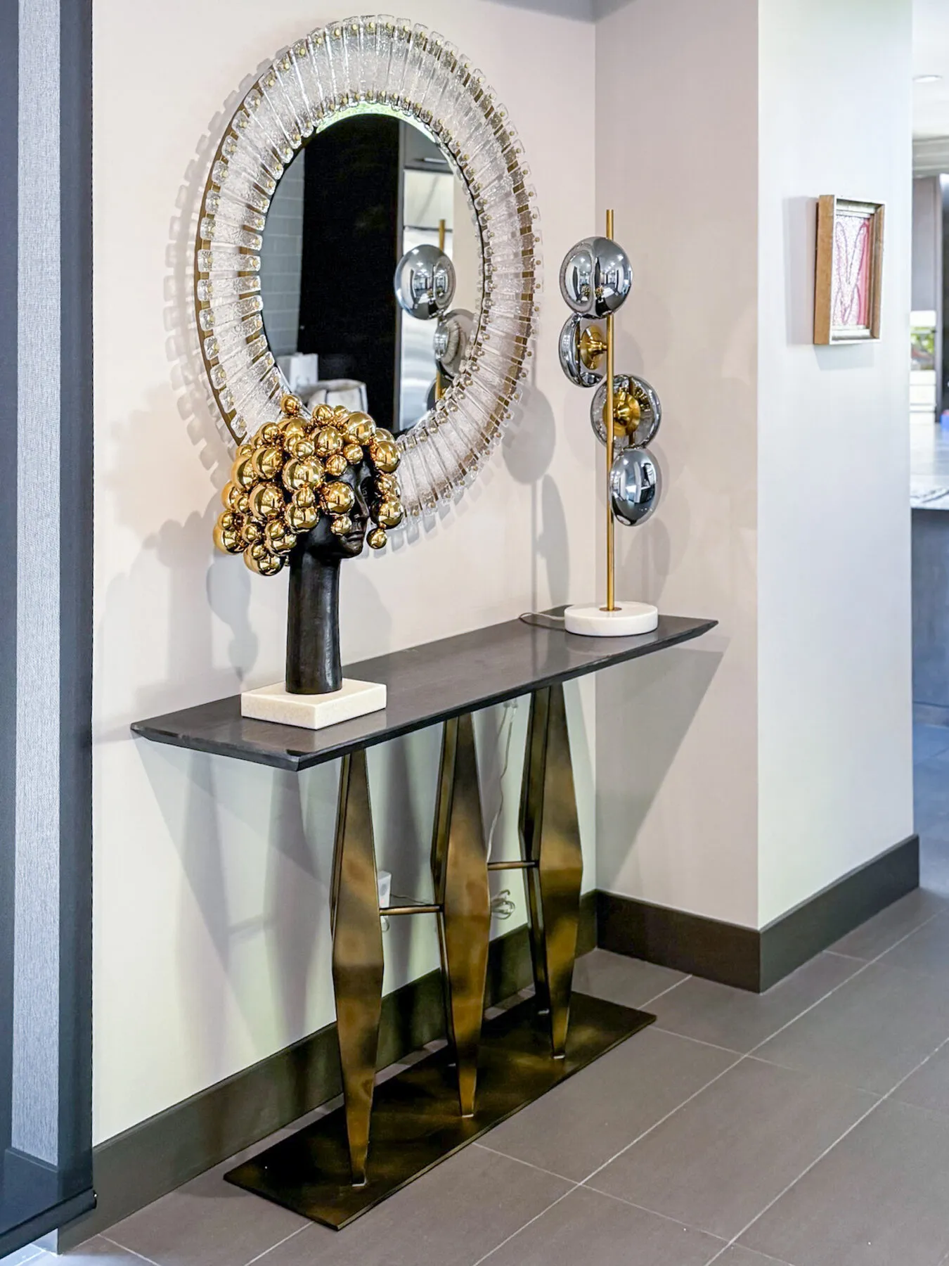 Crystal Sunburst Mirror Over a Sculpted Bronze Console