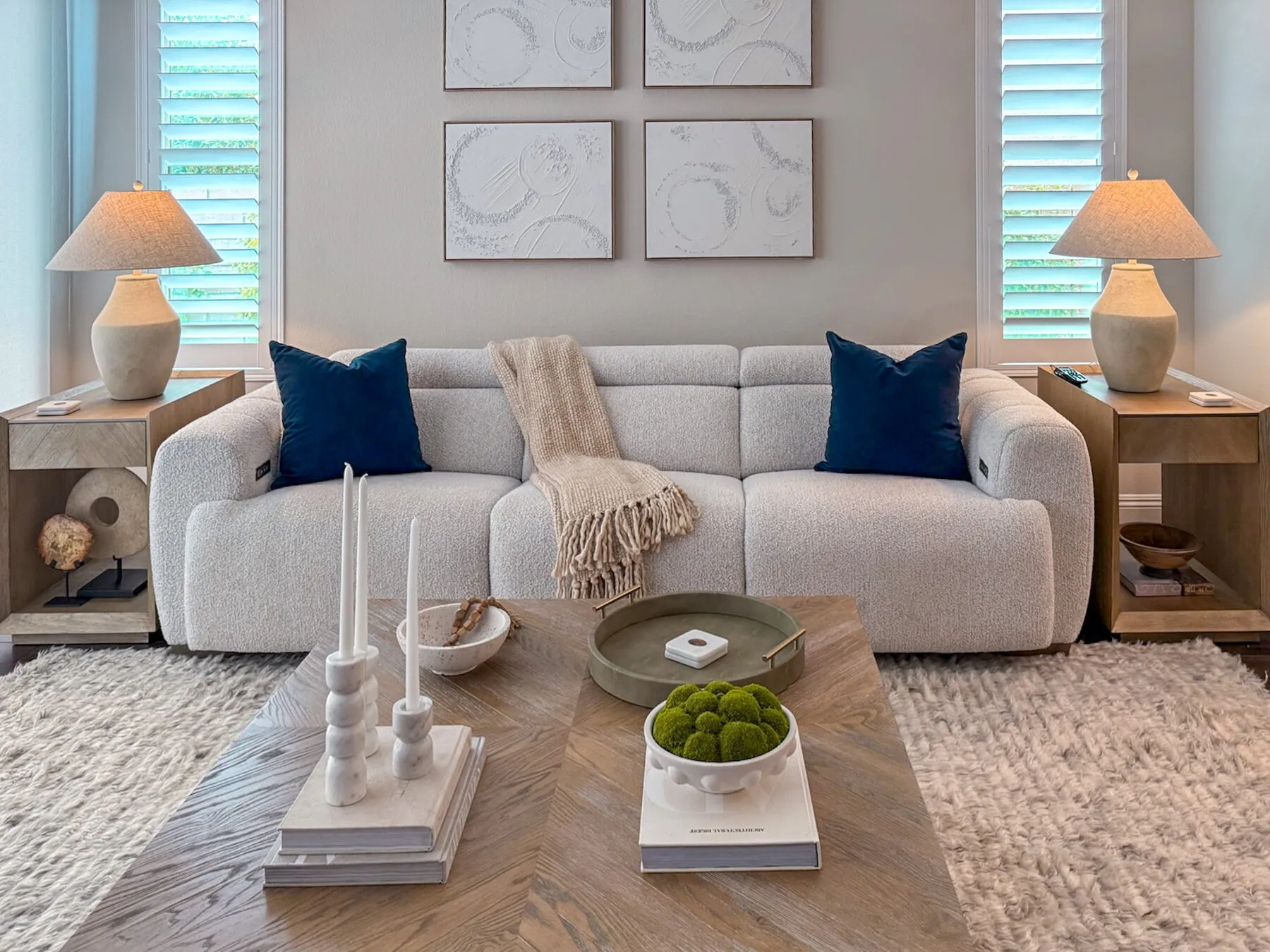 Boucle Sofa Beneath Three Circular Abstracts