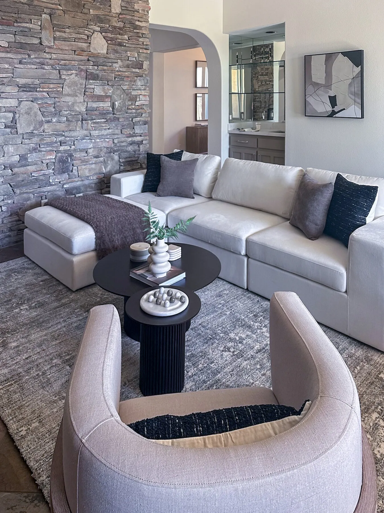 Ledgestone Wall Behind a Curved Sectional