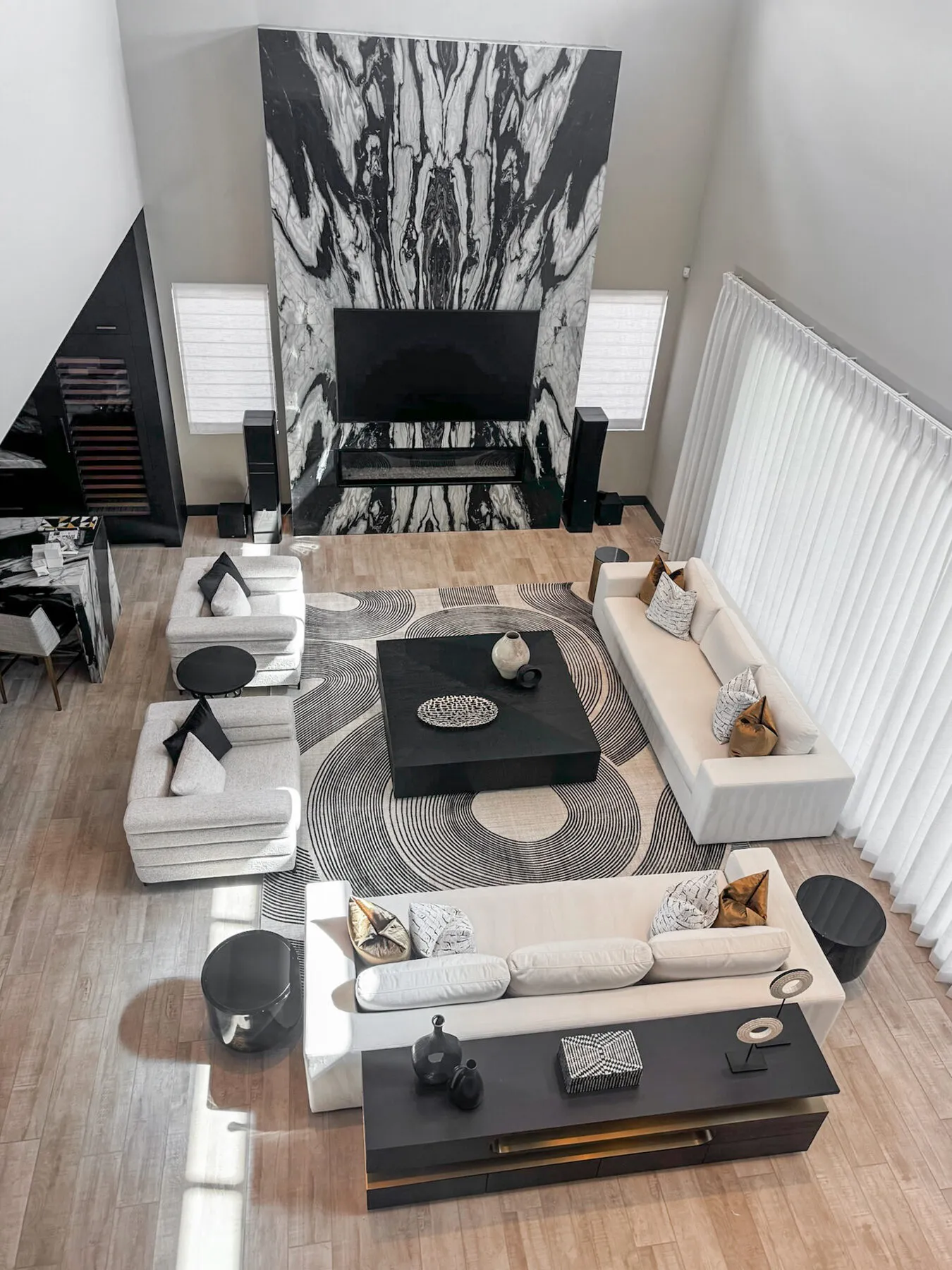 Aerial View of a Marble TV Wall and Circular Rug