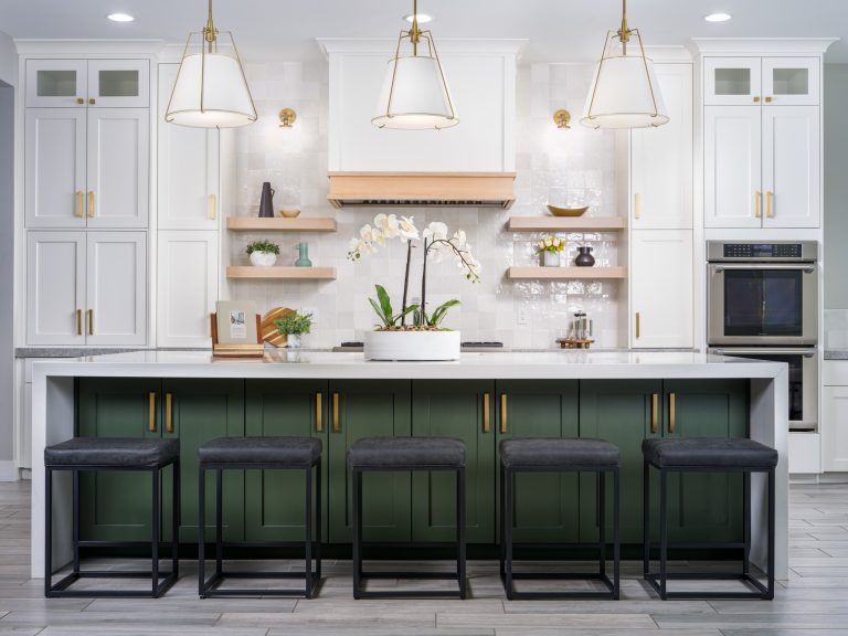 Luxury Home Staging featuring a modern kitchen with a green island, white cabinets, gold accents, and luxury interior design elements.